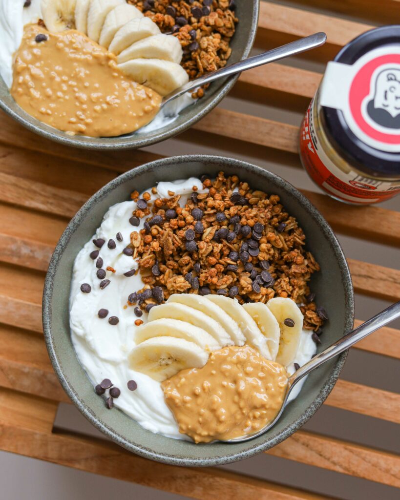 Bowls of yogurt with granola, banana and Drive Me Nuts peanut butter